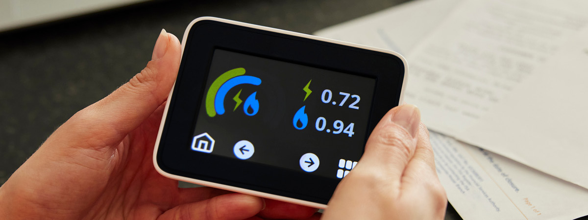 A smart meter being held in a person's hands
