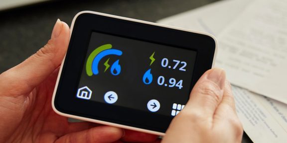 A smart meter being held in a person's hands